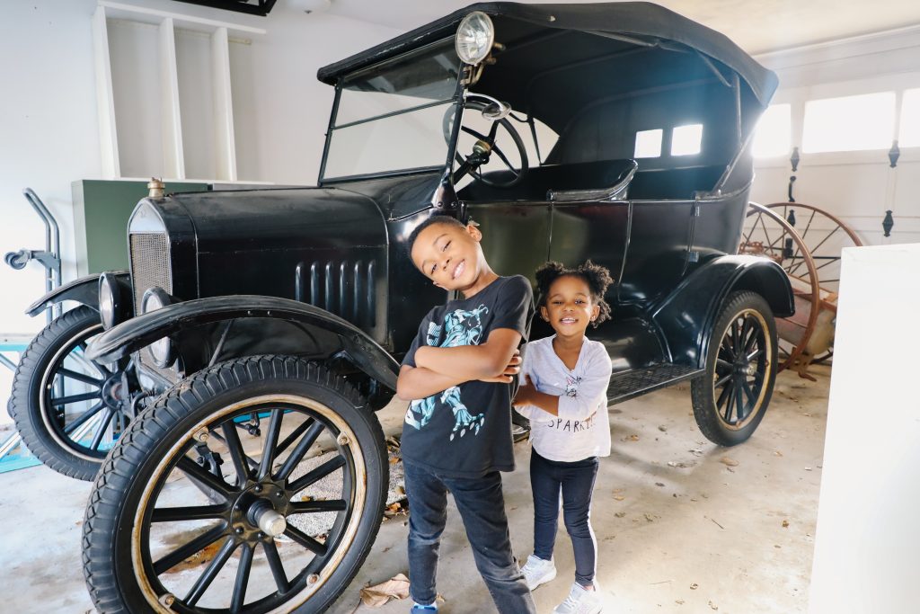 two kids in front of antique car at the Thomasville History museum