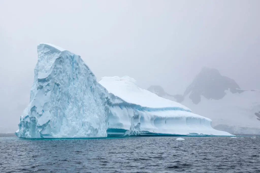 medium to large iceberg floating in the sea