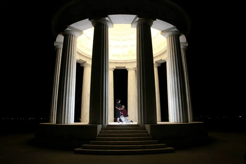 Photo of couple inside the Jefferson Memorial at night