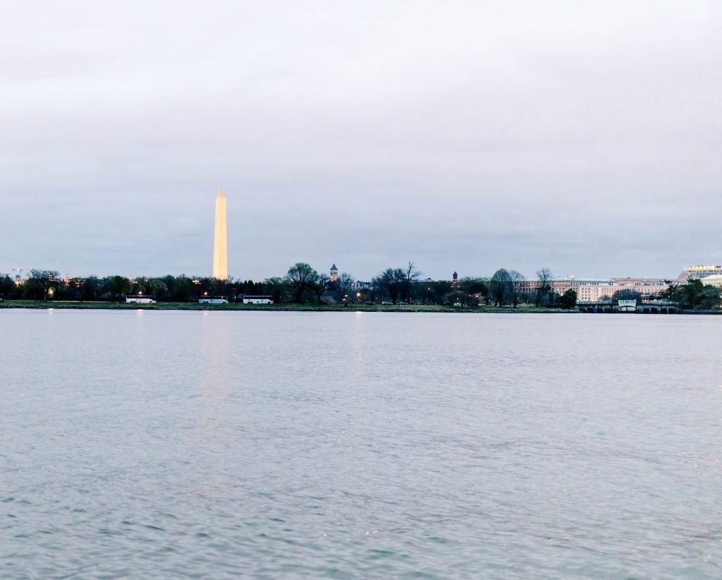 Image of the Washington Monument during twilight from a boat on the Potomac River.