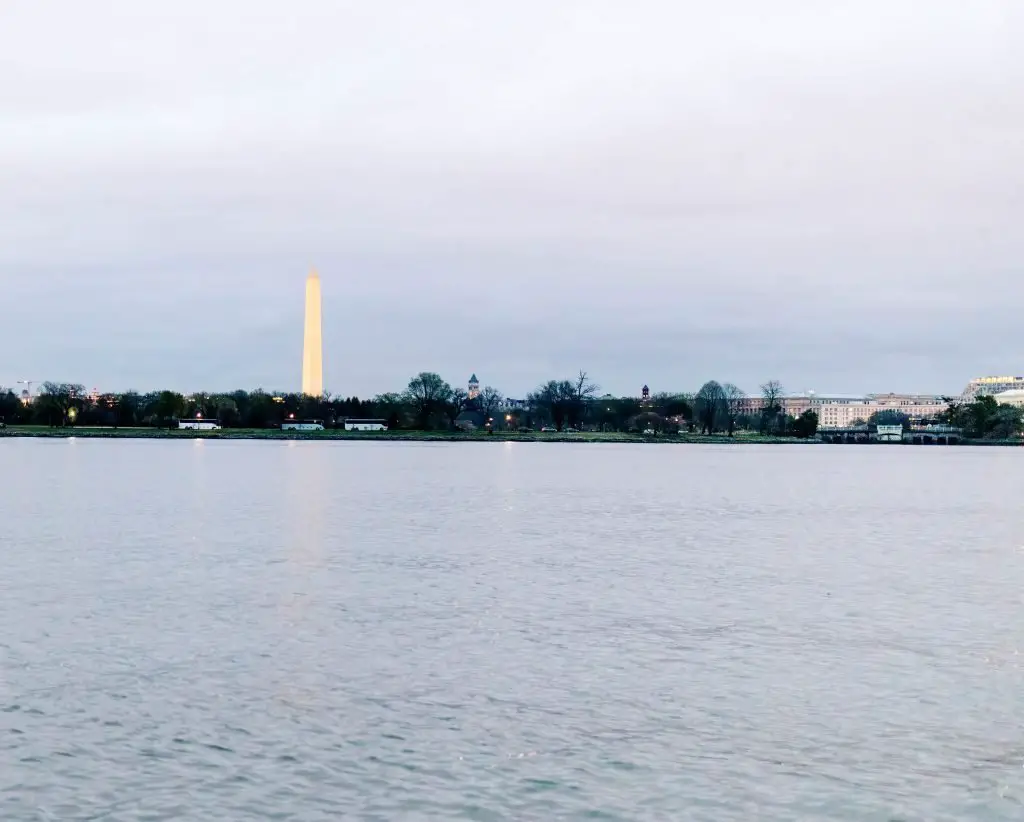 Image of the Washington Monument during twilight from a boat on the Potomac River.