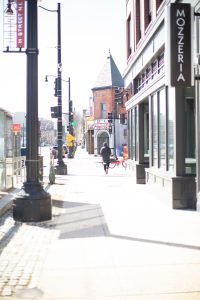 Photo of person walking down the sidewalk along H Street in Washington, DC 