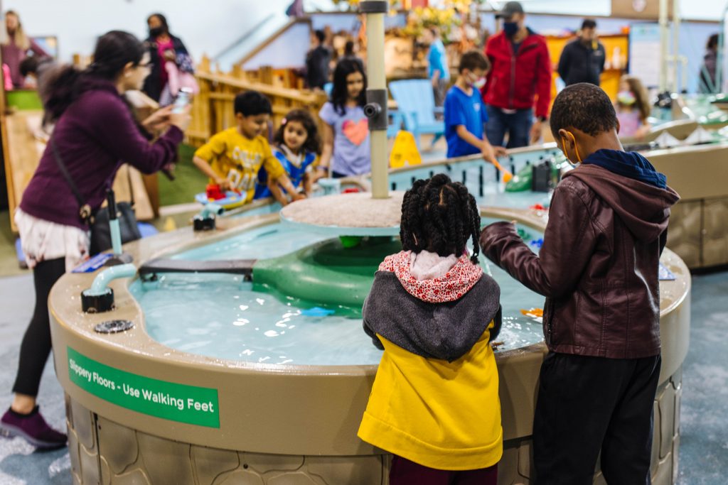 children playing in water at museum