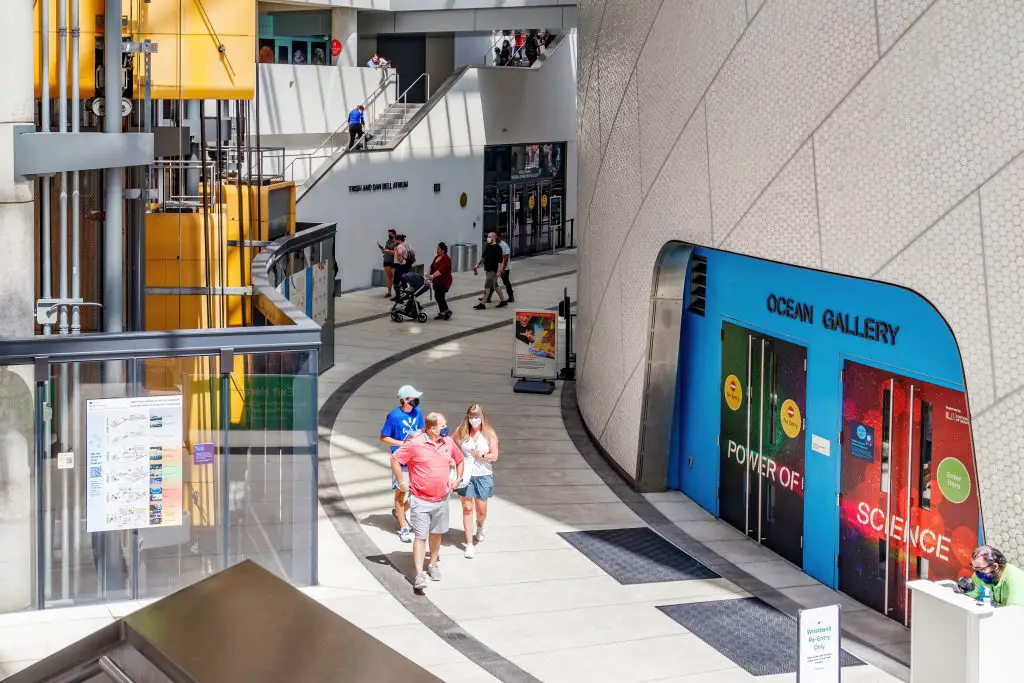 people walking with masks on inside of the Frost Science Museum in Miami