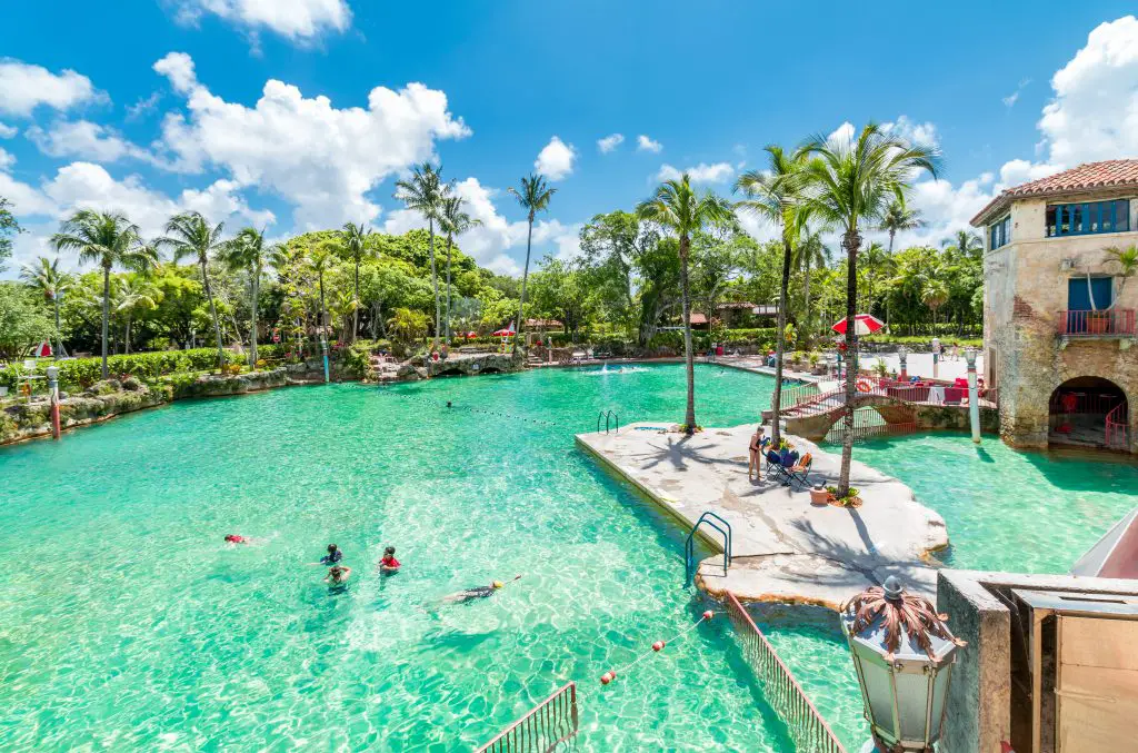 kids swimming in large, pretty venetian pool