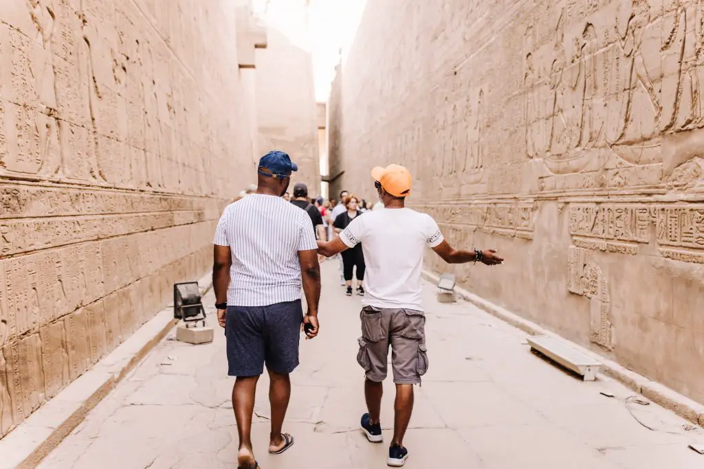 Two men walking and talking in Edfu, Temple