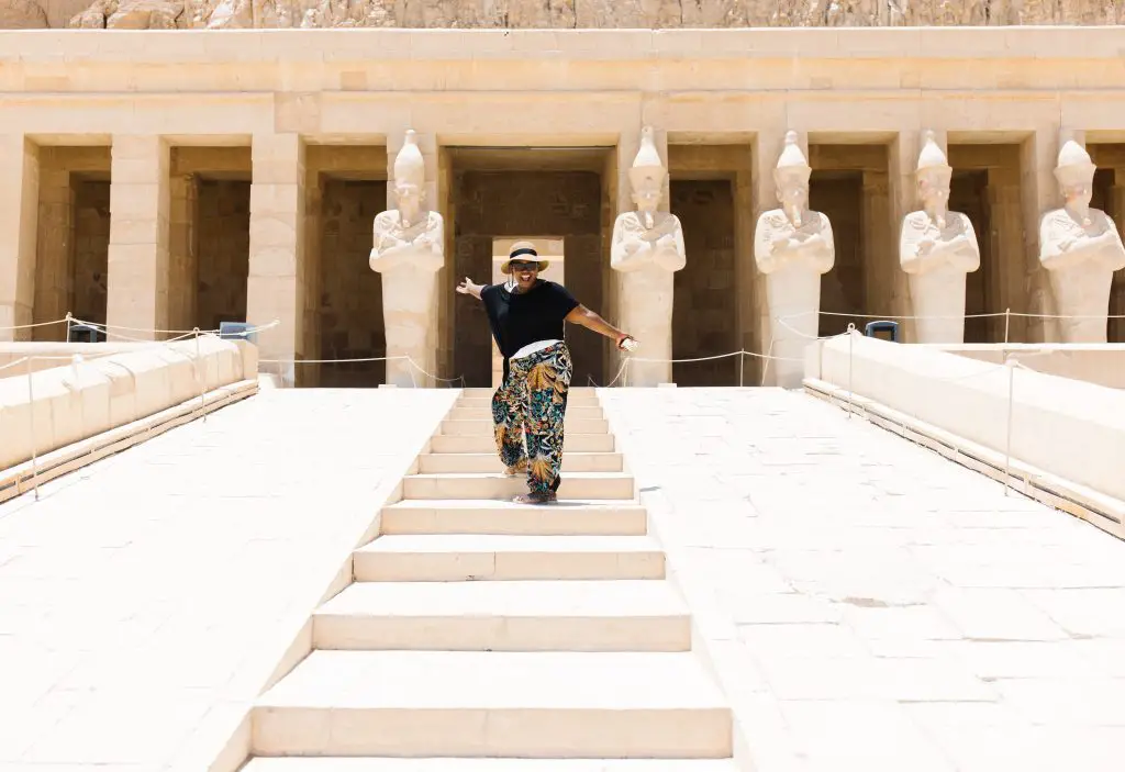 Woman smiling in front of the entrance to the Temple of Queen Hathshepsut