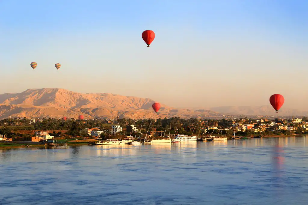 hot air balloons flying over luxor and the nile river