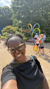 Selfie of woman with the Busch Gardens emblem behind her